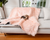 Yorkie dog resting on blush pink faux fur blanket