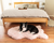 Border Collie resting on blush pink faux fur orthopedic pet bed