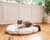 Cat on White Faux Fur Bed on Wood Floor