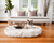 Cat on White Faux Fur Bed on Wood Floor in Living Room in front of matching white couch