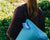 Woman holding travel paw.com dog bed bag on shoulder