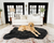 golden retriever on black faux fur bed in front of white couch and black french doors