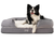 black and white dog on polar white faux fur topper on bolster dog bed