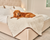 golden retriever resting on polar white faux fur pet blanket on bed